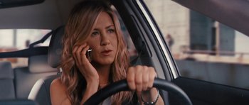 Movie still from “The Bounty Hunter” (2010), directed by Andy Tennant – A woman sitting in a car while talking on a cell phone; Close Up shot, High angle