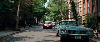 Movie still from “The Bounty Hunter” (2010), directed by Andy Tennant – Cars parked on the side of the road on a sunny day; Extreme Wide shot, High angle