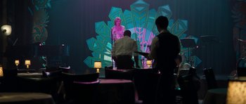 Movie still from “The Bounty Hunter” (2010), directed by Andy Tennant – A woman standing in front of a projector screen; Wide shot, Over the shoulder angle