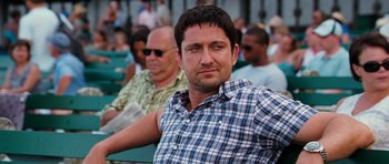 Movie still from “The Bounty Hunter” (2010), directed by Andy Tennant – A person wearing a plaid shirt; Close Up shot, Over the shoulder angle