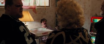 Movie still from “The Bounty Hunter” (2010), directed by Andy Tennant – A man sitting in front of a woman holding a pizza box; Medium shot, Over the shoulder angle