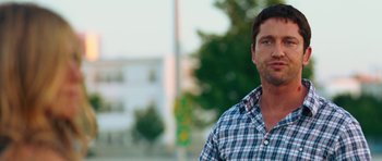 Movie still from “The Bounty Hunter” (2010), directed by Andy Tennant – A person wearing a plaid shirt; Close Up shot, Over the shoulder angle