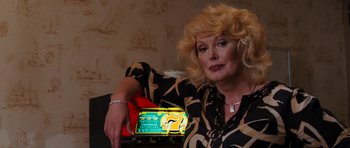 Movie still from “The Bounty Hunter” (2010), directed by Andy Tennant – A woman sitting at a table with a box of food; Close Up shot, Over the shoulder angle