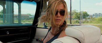 Movie still from “The Bounty Hunter” (2010), directed by Andy Tennant – A woman sitting in the passenger seat of a car; Close Up shot, Over the shoulder angle