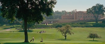 Movie still from “The Bounty Hunter” (2010), directed by Andy Tennant – A group of people playing golf on a green; Extreme Wide shot, Low angle