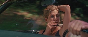 Movie still from “The Bounty Hunter” (2010), directed by Andy Tennant – A woman sitting in the back seat of a car holding a cell phone to her ear; Close Up shot, High angle