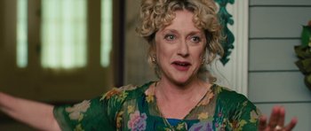 Movie still from “The Bounty Hunter” (2010), directed by Andy Tennant – A person with curly blonde hair; Close Up shot, Over the shoulder angle