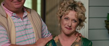 Movie still from “The Bounty Hunter” (2010), directed by Andy Tennant – A person with a woman in a green dress; Close Up shot, Over the shoulder angle