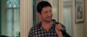 Movie still from “The Bounty Hunter” (2010), directed by Andy Tennant – A person holding a microphone; Close Up shot, Over the shoulder angle