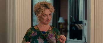 Movie still from “The Bounty Hunter” (2010), directed by Andy Tennant – A woman with curly blonde hair wearing a green floral shirt; Close Up shot, Over the shoulder angle