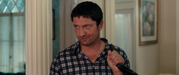 Movie still from “The Bounty Hunter” (2010), directed by Andy Tennant – A person holding a remote control; Close Up shot, Over the shoulder angle