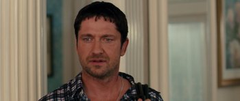 Movie still from “The Bounty Hunter” (2010), directed by Andy Tennant – A person holding a cell phone; Close Up shot, Over the shoulder angle