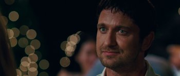 Movie still from “The Bounty Hunter” (2010), directed by Andy Tennant – A person with a blurry background; Close Up shot, Over the shoulder angle