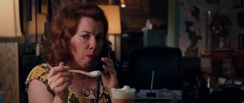 Movie still from “The Bounty Hunter” (2010), directed by Andy Tennant – A woman talking on a phone while sitting at a table; Close Up shot, Over the shoulder angle