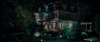 Movie still from “The Bounty Hunter” (2010), directed by Andy Tennant – A house that is lit up at night time; Extreme Wide shot, High angle
