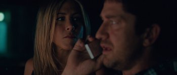 Movie still from “The Bounty Hunter” (2010), directed by Andy Tennant – A woman looking at a man holding a piece of chocolate; Close Up shot, Over the shoulder angle