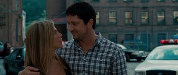 Movie still from “The Bounty Hunter” (2010), directed by Andy Tennant – A man and a woman standing next to each other; Close Up shot, Over the shoulder angle