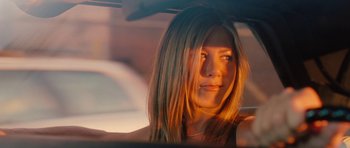 Movie still from “The Bounty Hunter” (2010), directed by Andy Tennant – A person sitting in a car; Close Up shot, Over the shoulder angle