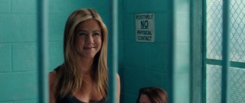 Movie still from “The Bounty Hunter” (2010), directed by Andy Tennant – A woman standing in front of a blue wall; Close Up shot, Over the shoulder angle