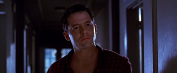 Movie still from “The Cable Guy” (1996), directed by Ben Stiller – A person wearing a red and black shirt; Close Up shot, Low angle