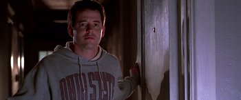 Movie still from “The Cable Guy” (1996), directed by Ben Stiller – A man standing in front of a wall; Close Up shot, Low angle