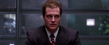 Movie still from “The Cable Guy” (1996), directed by Ben Stiller – A person wearing a suit and tie; Close Up shot, Low angle
