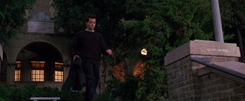 Movie still from “The Cable Guy” (1996), directed by Ben Stiller – A man walking down a street at night; Wide shot, High angle