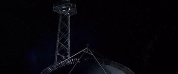 Movie still from “The Cable Guy” (1996), directed by Ben Stiller – A tower with a red light on top of it; Extreme Wide shot, Low angle