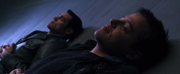 Movie still from “The Cable Guy” (1996), directed by Ben Stiller – Two men laying on the ground looking up at the sky; Close Up shot, High angle