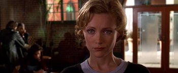 Movie still from “The Cable Guy” (1996), directed by Ben Stiller – A person with short blonde hair; Close Up shot, Over the shoulder angle