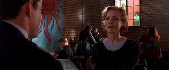 Movie still from “The Cable Guy” (1996), directed by Ben Stiller – A woman standing in front of a brick wall; Medium shot, Over the shoulder angle