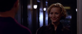 Movie still from “The Cable Guy” (1996), directed by Ben Stiller – A person wearing a leather jacket smiling; Close Up shot, Over the shoulder angle