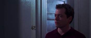 Movie still from “The Cable Guy” (1996), directed by Ben Stiller – A person standing in front of a door; Close Up shot, Over the shoulder angle