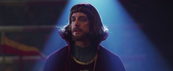 Movie still from “The Cable Guy” (1996), directed by Ben Stiller – A man with a beard wearing a purple cape; Close Up shot, Low angle