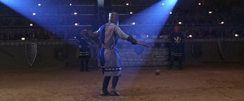 Movie still from “The Cable Guy” (1996), directed by Ben Stiller – A man in medieval garb holding a sword and mace; Wide shot, High angle