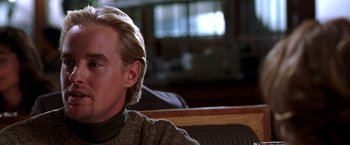 Movie still from “The Cable Guy” (1996), directed by Ben Stiller – A person sitting on a couch; Close Up shot, Over the shoulder angle