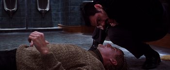 Movie still from “The Cable Guy” (1996), directed by Ben Stiller – Two men are fighting over a man lying on the ground; Medium shot, High angle