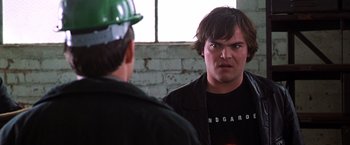 Movie still from “The Cable Guy” (1996), directed by Ben Stiller – A man in a hard hat stares into a mirror; Close Up shot, Over the shoulder angle