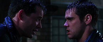 Movie still from “The Cable Guy” (1996), directed by Ben Stiller – Two men face each other in the dark; Close Up shot, Over the shoulder angle