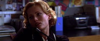Movie still from “The Cable Guy” (1996), directed by Ben Stiller – A woman holding a phone up to her ear; Close Up shot, Low angle
