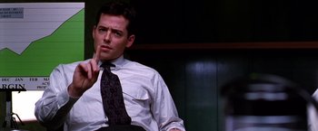 Movie still from “The Cable Guy” (1996), directed by Ben Stiller – A man in a dress shirt and tie sitting down; Close Up shot, Low angle