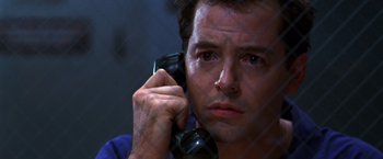 Movie still from “The Cable Guy” (1996), directed by Ben Stiller – A person talking on a cell phone; Close Up shot, Low angle