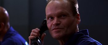 Movie still from “The Cable Guy” (1996), directed by Ben Stiller – A man holding a phone up to his ear; Close Up shot, Low angle