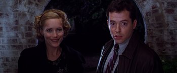 Movie still from “The Cable Guy” (1996), directed by Ben Stiller – A man and a woman standing next to each other in front of trees; Close Up shot, Over the shoulder angle