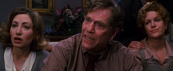Movie still from “The Cable Guy” (1996), directed by Ben Stiller – An older man with a frowning look on his face; Close Up shot, Over the shoulder angle