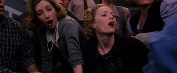 Movie still from “The Cable Guy” (1996), directed by Ben Stiller – A group of people that are sitting in a room together; Close Up shot, Low angle