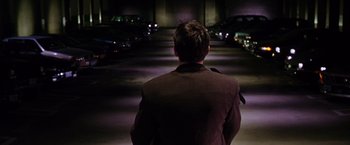 Movie still from “The Cable Guy” (1996), directed by Ben Stiller – A man in a suit standing in the middle of a street; Wide shot, High angle