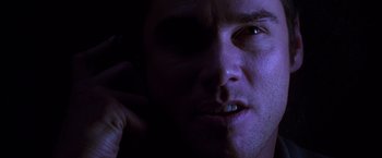 Movie still from “The Cable Guy” (1996), directed by Ben Stiller – A man's face in the dark; Extreme Close Up shot, Low angle