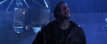Movie still from “The Cable Guy” (1996), directed by Ben Stiller – A man in a black jacket is crying in the rain; Close Up shot, Low angle