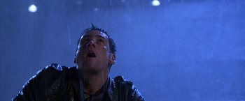 Movie still from “The Cable Guy” (1996), directed by Ben Stiller – A man in a black leather jacket is in the rain; Close Up shot, Low angle